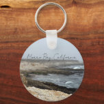 Chaveiro Morro Bay California Coastal Photography<br><div class="desc">A foggy overcast day in Morro Bay California with the ocean waves hitting the rocks on the shore in this beach photograph souvenir. This seaside travel photo keepsake keychain features black cursive script above the beach rocks and grey sky.</div>