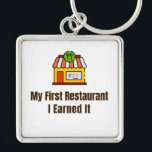 Chaveiro My First Restaurant Keychain – I Earned It – Proud<br><div class="desc">Celebrate the pride of opening your very first restaurant! This keychain features the bold phrase "My First Restaurant – I Earned It", perfect for anyone who worked hard to achieve this milestone. Whether it’s a diner, café, or full-service restaurant, this keychain is a fun and meaningful reminder of dedication and...</div>