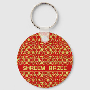 Chaveiro O canto Dourado vermelho Shreem Brzee atrai a