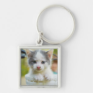 Chaveiro O gatinho monta uma bicicleta