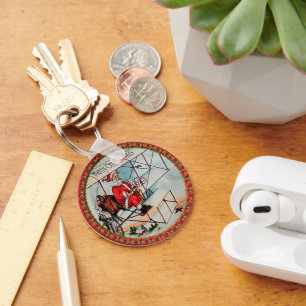 Chaveiro Papais noeis de Natal voando em um avião antigo