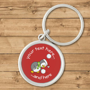 Chaveiro Pinguim de Natal ganhando uma bola de neve