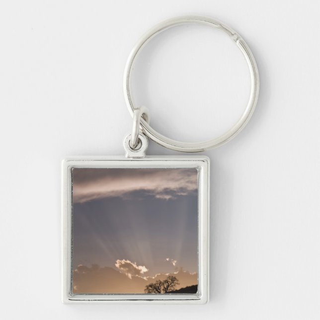 Chaveiro Raios crepusculares irradiam pelo céu a (Frente)