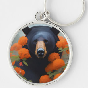 Chaveiro Urso Negro em flores laranja