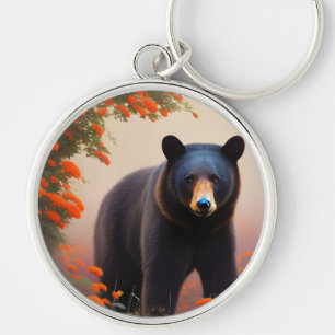 Chaveiro Urso Negro em flores laranja