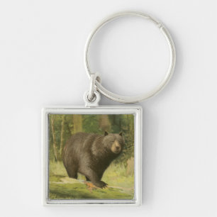 Chaveiro Urso Preto a Passar num Tronco de Árvore