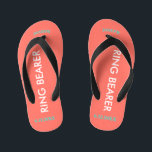 Chinelos Infantis Ring Bearer NAME Coral<br><div class="desc">O Ring Bearer é escrito em texto branco contra cor de coral brilhante com sotaques pretos. O nome e a data do casamento é azul-turquesa. Personalize o nome do seu menino do anel em letras maiúsculas arqueadas. Clique em Personalizar para aumentar ou diminuir o tamanho do nome para cair dentro...</div>
