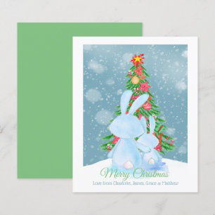 Coelhos de coelho de Natal com árvore na neve