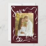 Convite Burgundy Photo Whimsical Romantic Save the Date<br><div class="desc">Announce your special day with this elegant burgundy photo Save the Date card featuring modern handwritten typography, delicate decorative line accents, and a romantic engagement photo layout. The deep burgundy background paired with soft white script creates a timeless and sophisticated look, making it perfect for fall, winter, or classic romantic...</div>