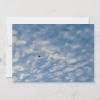 Convites Airplane Crossing a Cloud-Filled Blue Sky