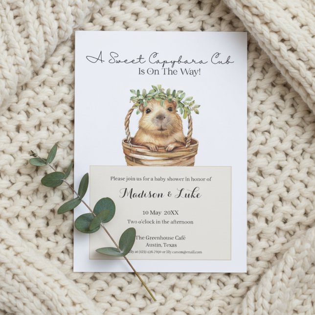 Convites Capybara Baby Shower • Eucalyptus Design (Baby shower invitation with capybara design on cream knitted blanket and eucalyptus sprig)