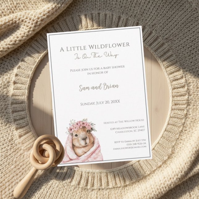 Convites Capybara Baby Shower • Little Wildflower (warm boho invitation mockup with wooden rattle and knit details on soft neutral background)