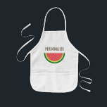 Cutie caçoa o avental do cozimento com fatia<br><div class="desc">Avental bonito do cozimento/cozinhar do miúdo com logotipo bonito da fatia da melancia. Design da comida do divertimento para as crianças que fazem artes e artesanatos ou que aprendem como cozinhar e cozer. Ilustração da comida do verão com tipografia bonito. Aventais feitos sob encomenda do CHURRASCO que podem ser personalizados...</div>