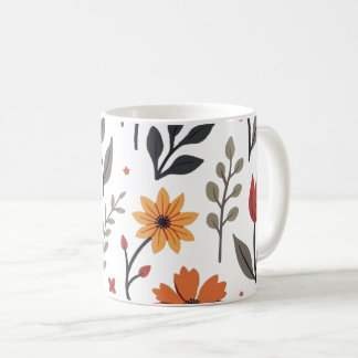 É uma caneca decorada com flores e folhas.