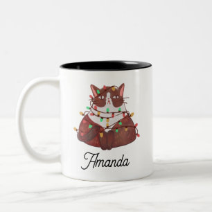 Em Dois Tons Gato bonito com luz de natal Uma caneca de café de