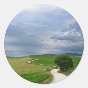 Estrada Curvy para uma etiqueta redonda do destino