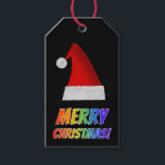 Etiqueta Para Presente "MERRY CHRISTMAS!" em texto arco-íris, Red Santa H<br><div class="desc">Este divertido design de etiqueta de presente de Natal apresenta a mensagem "MERRY CHRISTMAS!" com letras com um padrão colorido de gradação do espectro do arco-íris. Ele também apresenta uma representação de Papais noeis vermelhos.</div>