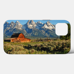 Farms Barn Shadowed by Snow Capped Mountains