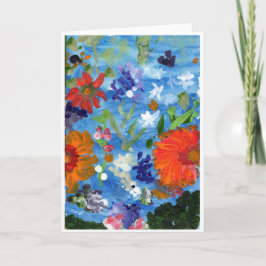Flores no cartão de nota azul do fundo