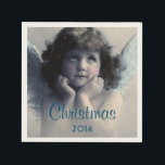 Guardanapo De Papel Doce Vintage Angel Christmas<br><div class="desc">Linda design de vintage de um doce anjo de Natal com asas brancas e brancas suaves e bochechas rosadas, segurando seu rosto em suas mãos. Parecendo tranquilo e gentil. O fundo está cheio de nuvens etéreas macios. O texto diz Natal 2014 em uma fonte azul bonito que você pode personalizar...</div>