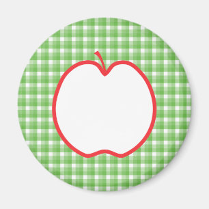 Íman Apple vermelho. Com fundo verde e branco da