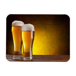 Íman Dois vidros das cervejas em uma mesa de madeira