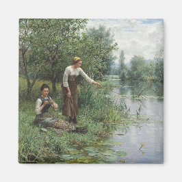 Íman Duas mulheres pescando na grama pelo rio