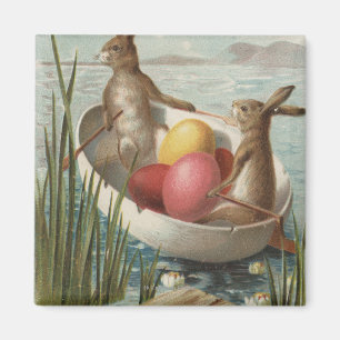 Íman EasterBunnies em um barco com ovos coloridos