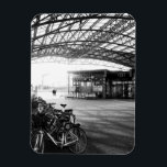 Íman Halle Train Station, Belgium<br><div class="desc">The black and white urban image of Halle Train Station in Flemish Brabant, Belgium captures the timeless beauty of the modern architecture, with light and shadow creating a dramatic interplay. The parked bicycle and the wheels of vehicles add a sense of movement to the stillness of the scene, while the...</div>