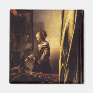 Íman Uma menina que lê uma letra em uma janela aberta