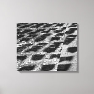 Impressão Em Tela B&W Cobblestone Street with Festival Flag Shadows