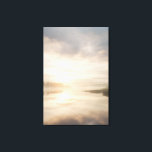 Impressão Em Tela Misty Lake Sunrise Golden Reflection<br><div class="desc">Soft golden sunlight pierces through thick morning mist over a calm lake, creating a luminous path of reflection across the water. Tall reeds line the shore while distant trees fade into the haze, and the sky blends warm peach and rose tones into pale blue-gray. The composition radiates profound stillness, gentle...</div>