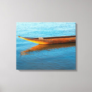 Impressão Em Tela Wooden Canoe Moored on Calm River Waters at Sunset