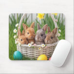 Mousepad Easter Baby Bunnies in a Basket<br><div class="desc">Four adorable bunnies are nestled in a white wicker basket with small flowers,  surrounded by brightly colored Easter eggs and vibrant blossoms in the grassy background</div>