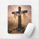 Mousepad Easter Crosses On a Hill<br><div class="desc">A central wooden cross,  covered with a white cloth and illuminated by the warm glow of the setting sun,  stands out against two additional crosses on a rocky hillside in the background</div>