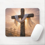 Mousepad Easter Crosses On a Hill<br><div class="desc">A central wooden cross,  covered with a white cloth and illuminated by the warm glow of the setting sun,  stands out against two additional crosses on a rocky hillside in the background</div>