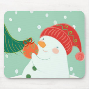Mousepad Um boneco de neve que pendura um ornamento em uma