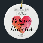 Nosso primeiro Natal engajado ou unido ornamento<br><div class="desc">Nosso Natal de 1rua engajado ou unido com um coração de aquarela fofo. Personalizado com seus nomes em uma fonte de script tipográfico fofo.</div>