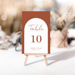 Numeração De Mesa Casamento de Script de Arch Terracotta Whimsical<br><div class="desc">Número da Tabela de Casamento de Script Queimado de Arco Timíístico Terracotta, impresso com design moderno e elegante, que pode ser personalizado com seu texto e adicionar cada placa de número de tabela ao seu carrinho, um a um. Clique no botão "Personalizar" e use nossa ferramenta design para modificar este...</div>