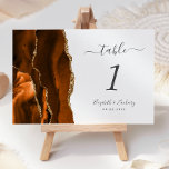 Numeração De Mesa Casamento Dourado de Agata Laranja Moderno Queimad<br><div class="desc">A borda esquerda desta elegante e moderna placa de número da mesa de casamento apresenta uma borda de cor de água laranja queimada,  aparada com falsa brilho dourado. O texto personalizável combina a escrita manual de cinzas de carvão,  as fontes itálicas e de chapa em um fundo branco.</div>
