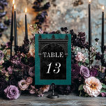 Numeração De Mesa Casamento Gótico de Arcos Negros Raven e Arco Negr<br><div class="desc">Traga seus convidados para um mundo de elegância escura e encantadora com nossa vintage gótica placa de número da mesa de casamento. O fundo verde verde-preto profundo, envelhecido, define a palco para um contraste impressionante, à medida que o texto branco em negrito emerge de intrincadas caixas de texto em preto....</div>