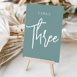 Numeração De Mesa Mesa com script de mão dupla três<br><div class="desc">Cartões simples e chic em aqua empoeirado e branco fazem uma declaração elegante no seu casamento ou evento. Design apresenta "mesa [number]" em uma combinação de olhares de serif clássica e de caracteres de script manuscritos. Design repete-se de ambos os lados. Cartões numerados individualmente vendidos separadamente; solicite cada número de...</div>