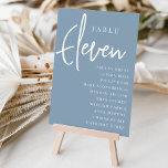 Numeração De Mesa Mesa Mão com Script ELEVEN   Nomes de Convidado<br><div class="desc">Cartões simples e chicos de números de mesas em Azul Dusty e branco fazem uma declaração elegante no seu casamento ou evento. Design apresenta "mesa [number]" em uma combinação de olhares de serif clássica e de caracteres de script manuscritos, com nomes individuais de convidados por baixo. Design repete-se de ambos...</div>