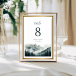 Numeração De Mesa Verdant Peaks Watercolor Mountain Table Number<br><div class="desc">Guide your guests to their seats with the atmospheric beauty of the Verdant Peaks | Watercolor Table Number. This elegant card features a hand-painted landscape of misty evergreen forests and towering mountain summits, perfectly capturing the spirit of the wilderness. Designed to coordinate seamlessly with the rest of the Verdant Peaks...</div>
