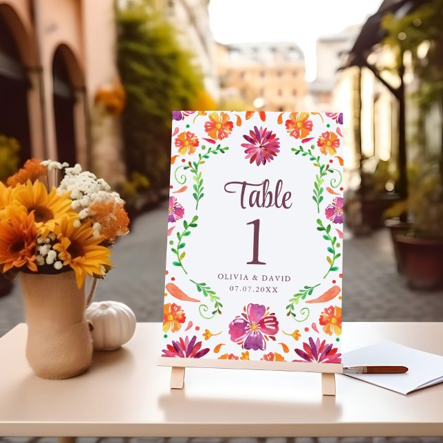 Número de Mesa de Casamento Floral Fiesta Mexicana (White Mexican Floral Fiesta Wedding Table Number on a table with flowers.)