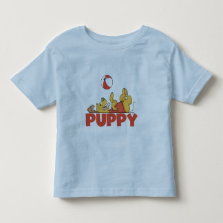 O filhote de cachorro joga o camiseta e os