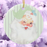 Ornamento De Cerâmica Árvore de Natal dos Papais noeis Vintage Verde<br><div class="desc">Este belo e pastel verde-primavera verde-verde-verde-de-Vintage Winking Papai noel ornamento de árvore de Natal apresenta um gráfico antigo do Papai Noel que foi recolhido e reimaginado. O plano de fundo é um padrão de distribuição vertical tritônica monocromática. O ornamento cerâmico é idêntico em ambos os lados.</div>