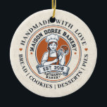 Ornamento De Cerâmica Bakery Store Pastry Chef Dessert Sweets Cake Baker<br><div class="desc">This vintage-style circular logo features a cheerful female pastry chef wearing a traditional white chef's hat and apron. She is framed by a warm orange circular backdrop and holds a wire whisk in one hand and a flaky croissant in the other, symbolizing her culinary expertise. Below her, a blank, elegant...</div>