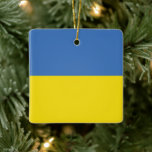 Ornamento De Cerâmica Bandeira da Ucrânia, Ucraniano Слава Україні Slava<br><div class="desc">As cores da bandeira da Ucrânia, azul e amarelo, voaram por séculos sobre uma terra rica em história e espírito. O azul representa o vasto céu ucraniano, enquanto o amarelo simboliza os campos de trigo dourado que se estendem pelas suas planícies férteis. Este símbolo simples, mas poderoso, tornou-se um farol...</div>