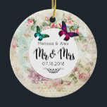 Ornamento De Cerâmica Borboletas em Shabby Vintage Collage Sr. e Sra.<br><div class="desc">Um ornamento de casamento projetado com borboletas em magenta rosa e verde esmeralda. Um quadro circular branco com os detalhes do seu casamento em camadas sobre uma colagem vintage shabby com rosas rosa e outros elementos decorativos. O Sr. e a Sra. escreveram em uma letra de roteiro de tendências de...</div>